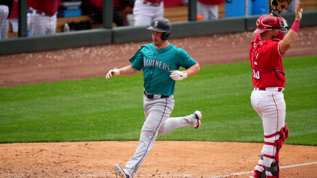 Seattle Mariners infielder Cole Tucker scores in the eighth inning during a MLB spring training baseball game against the Cincinnati Reds, Monday, Feb. 26, 2024, at Goodyear Ballpark in Goodyear, Ariz.